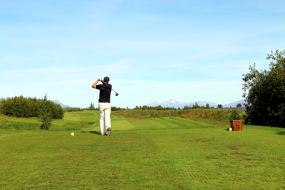 Man playing golf in Akureyri Iceland