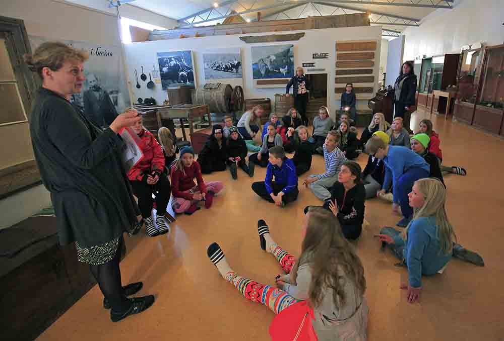 Group of kids listening to a story at Árbæjarsafn museum in Reykjavik Iceland