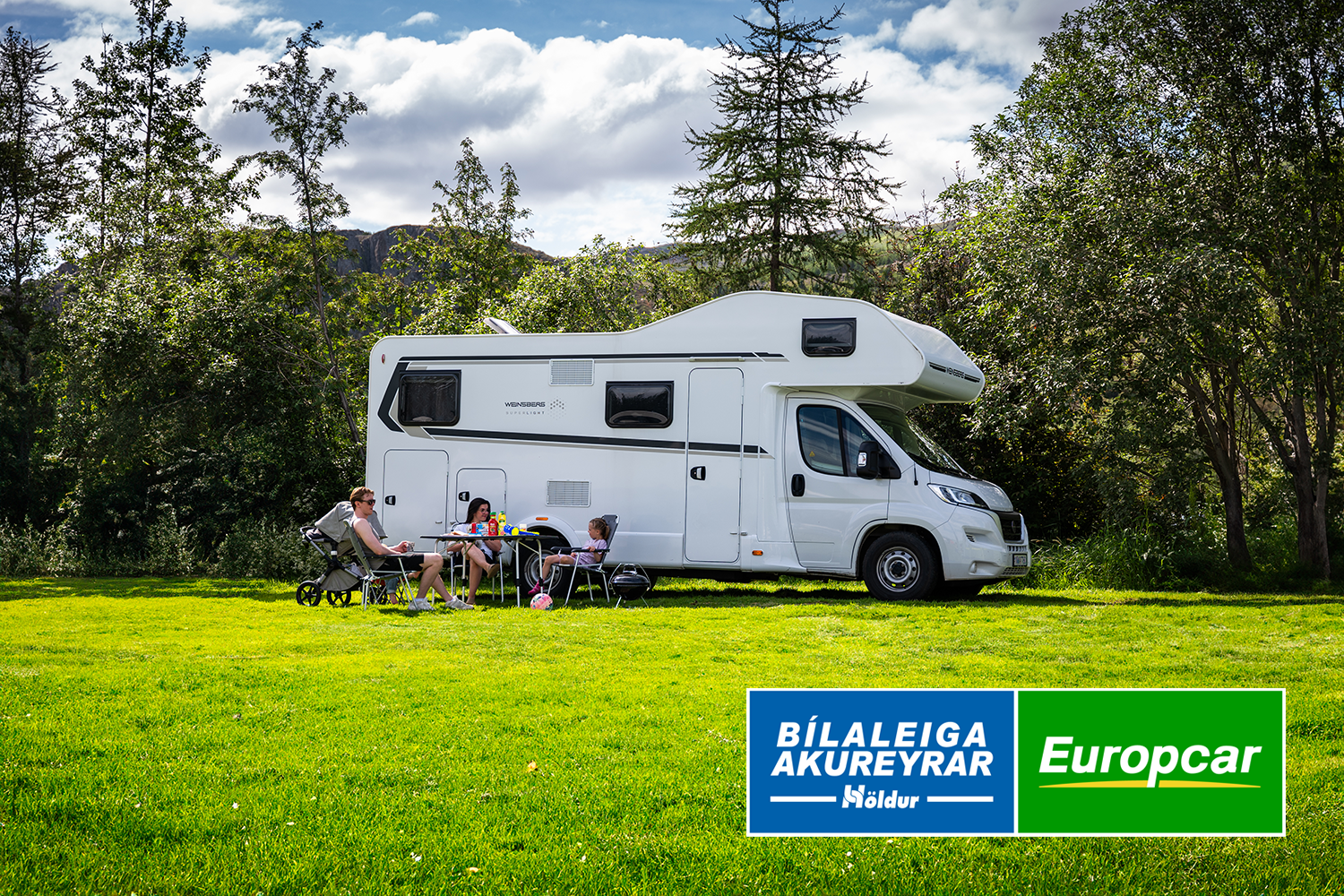 Family outside a camping car on a campsite near Akureyri in Iceland