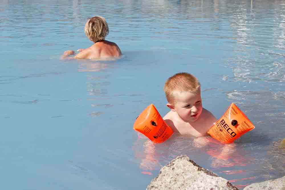 Child swimming in the Blue Lagoon in Iceland