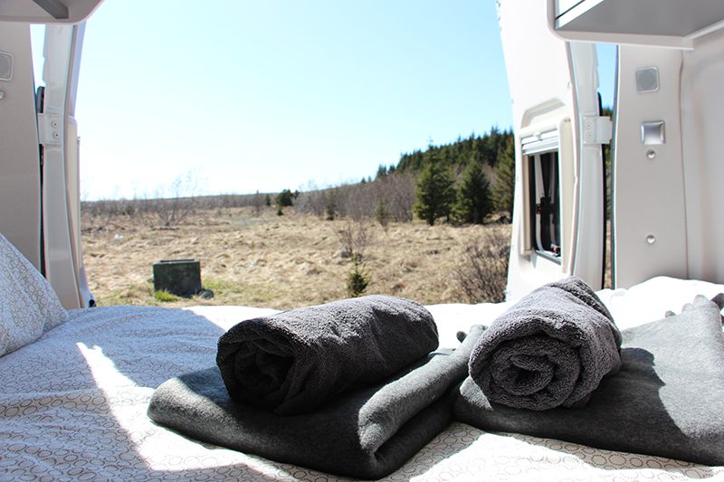 Bed and towels in the rear of a camping car from Holdur in Iceland