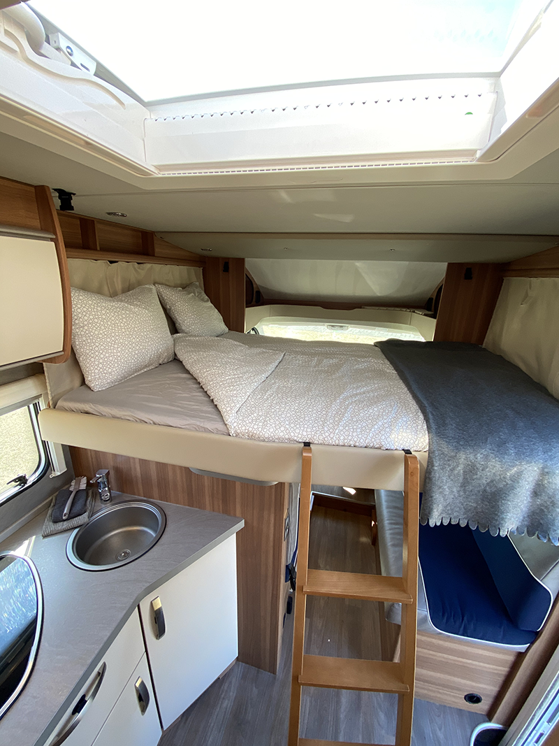 Bed and towels in the rear of a camping car from Holdur in Iceland